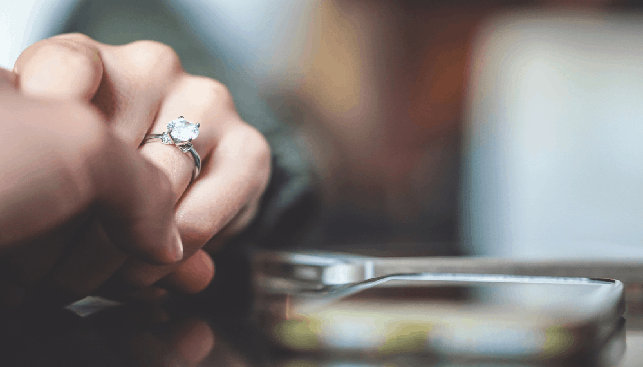 Diamond ring next to a smartphone