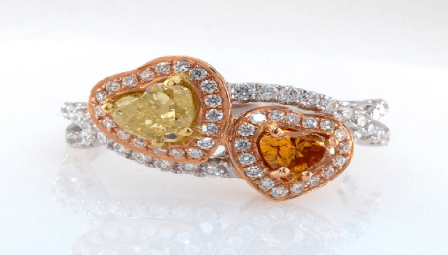 Heart Shaped Ring by Denir Diamonds in 18K gold, with natural fancy yellow and deep yellow orange diamonds, surrounded by small natural white diamonds. Center stones are GIA certified